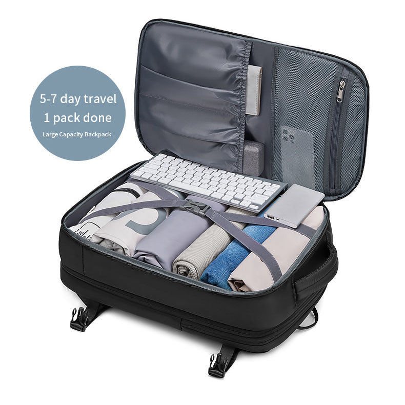 RolePack travel backpack unzipped 180 degrees flat, showing multi-compartment classified storage and mesh pockets packed with clothes