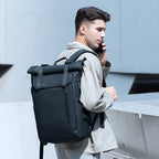Man wearing the RolePack 20L roll-up everyday daypack walking on a modern city street for a stylish work commute.