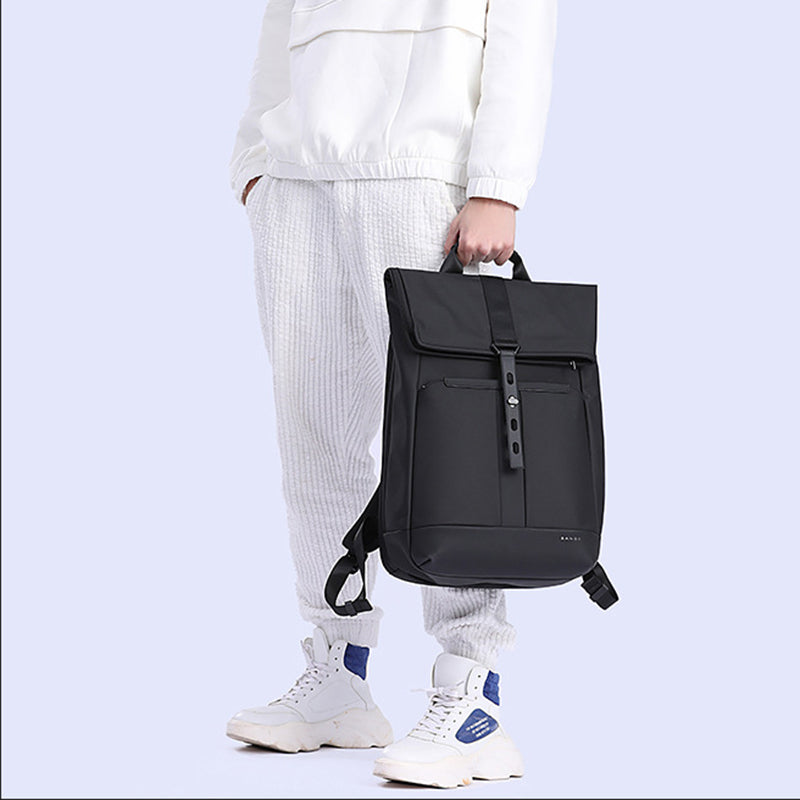 Model demonstrating a 20–30L roll-top everyday backpack by hand.