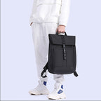 Model demonstrating a 20–30L roll-top everyday backpack by hand.