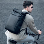 Cyclist wearing the durable ballistic Oxford roll-top ride backpack during an outdoor weekend travel trip.