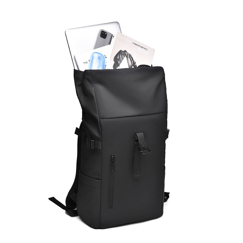 The 20L waterproof backpack in its fully unrolled state, demonstrating the expandable volume and magnetic top closure.