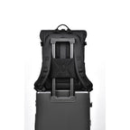 A rendering showing the back of the 20L travel backpack fitted over a suitcase's telescopic handle.