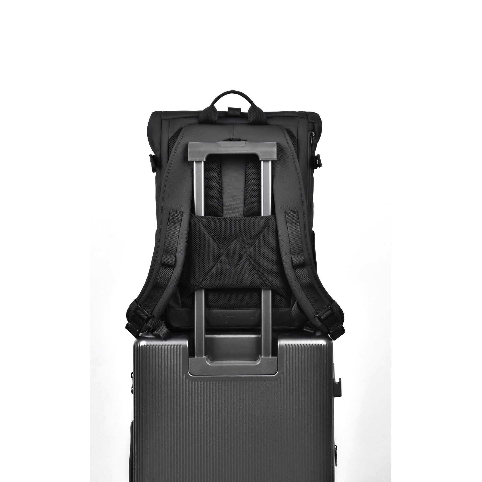 A rendering showing the back of the 20L travel backpack fitted over a suitcase's telescopic handle.