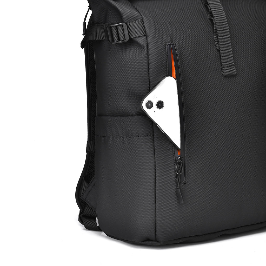Close-up of the heavy-duty YKK weatherproof vertical zipper on the front pocket of the black backpack.