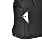 Close-up of the heavy-duty YKK weatherproof vertical zipper on the front pocket of the black backpack.