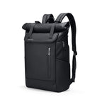 Matte black 20L roll-top commuter backpack with dual magnetic buckles and vertical zippered pocket on a white background.